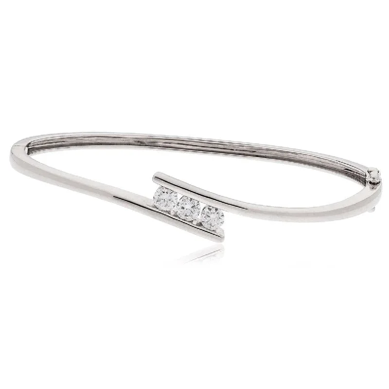 Women’s spiral bangles-DIAMOND THREE-STONE CROSS OVER BANGLE IN 18K WHITE GOLD